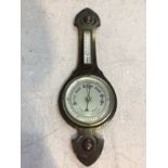 An aneroid banjo barometer with silvered dial and thermometer, 80cm high