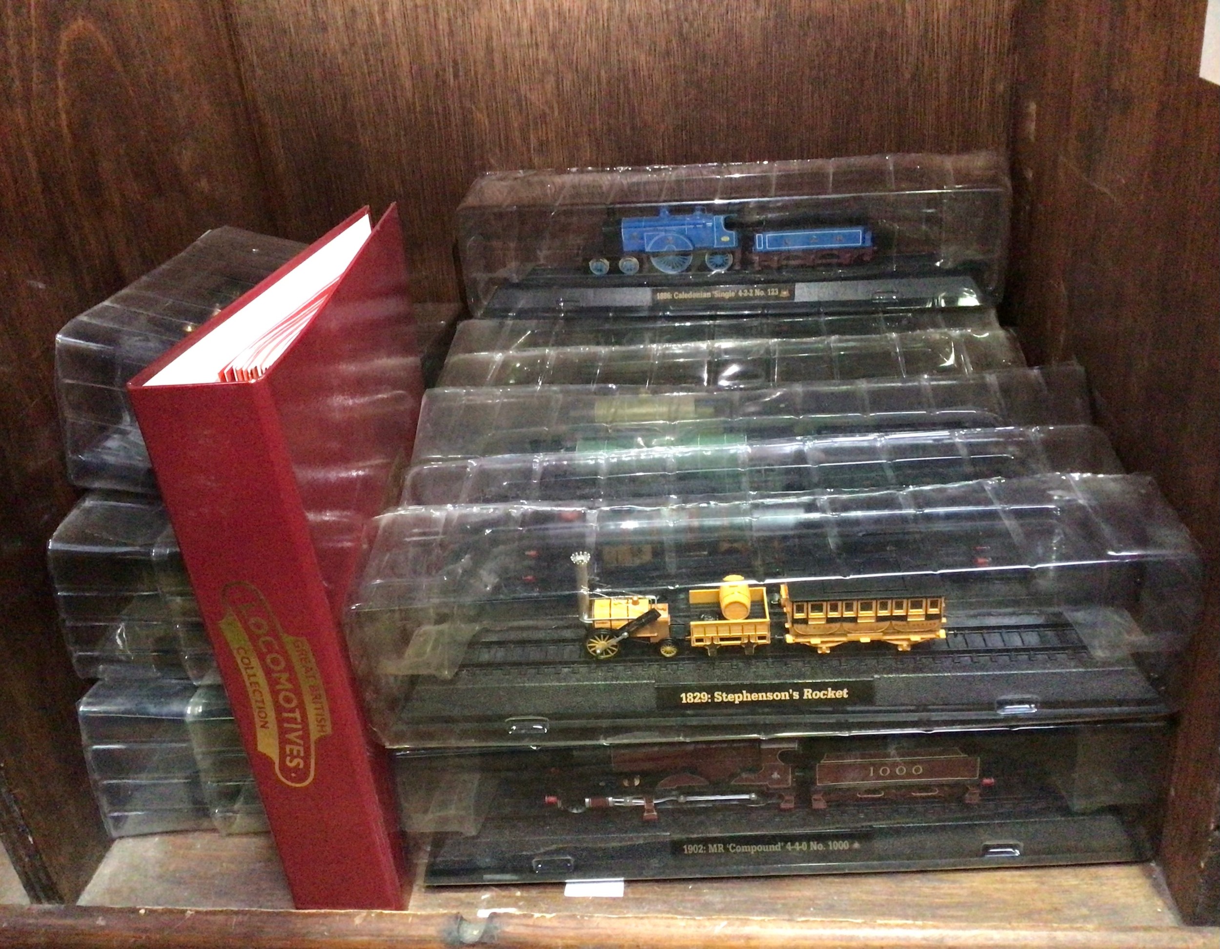 Eighteen various boxed locomotives together with a folder containing some Great British