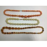 Three assorted strings of graduated beads including an amber coloured set and butterscotch etc.