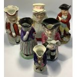 Six various 19th century Toby / character jugs including Punch & Judy, standing lady Snuff Taker,