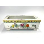 A 20th century Chinese porcelain rectangular trough, painted in polychrome enamels with flowers