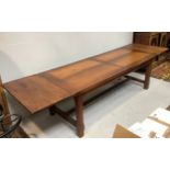 A very large 'antiqued' oak refectory table with two drawers to the side on square carved supports