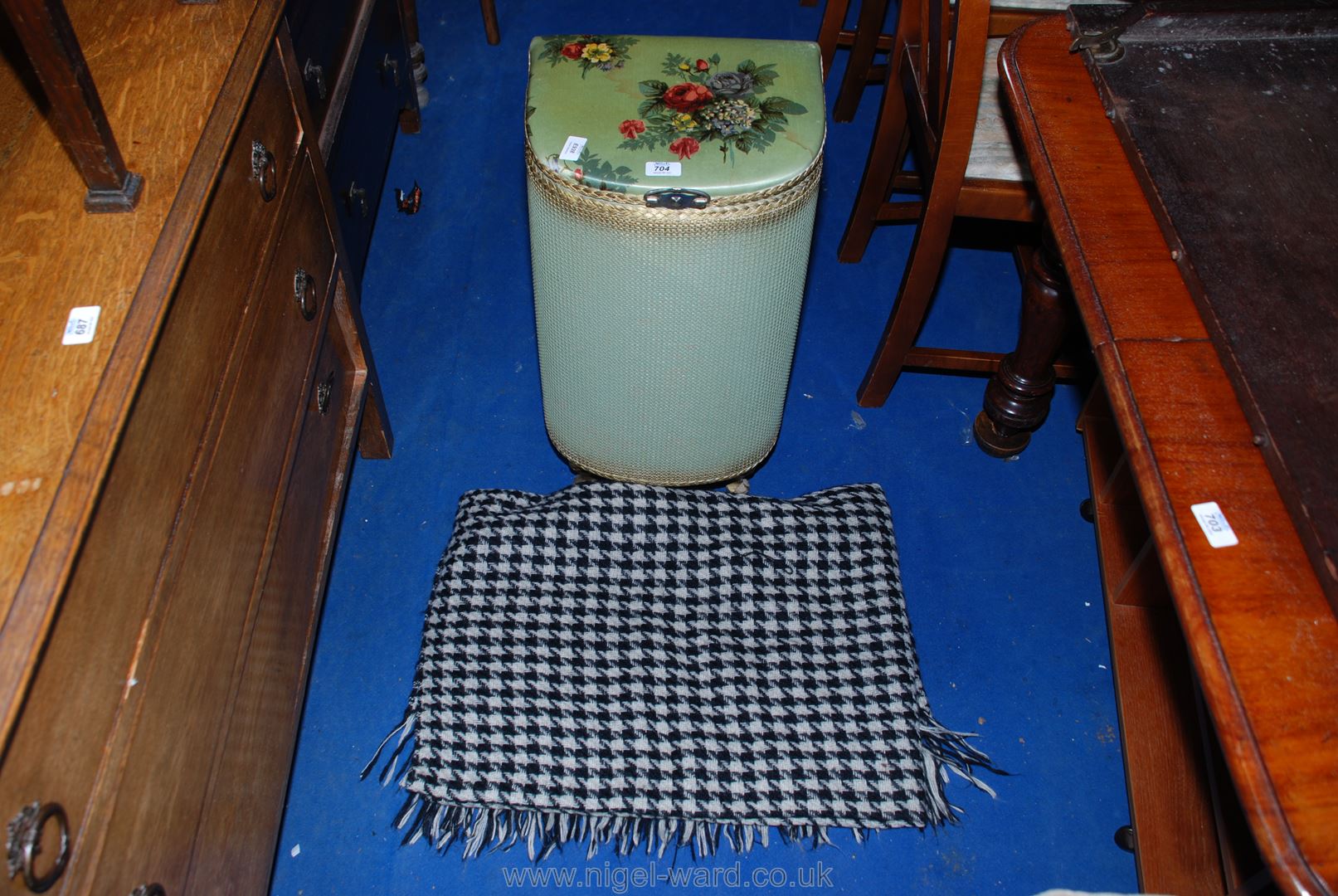 A Lloyd Loom style linen basket and a check-patterned throw.