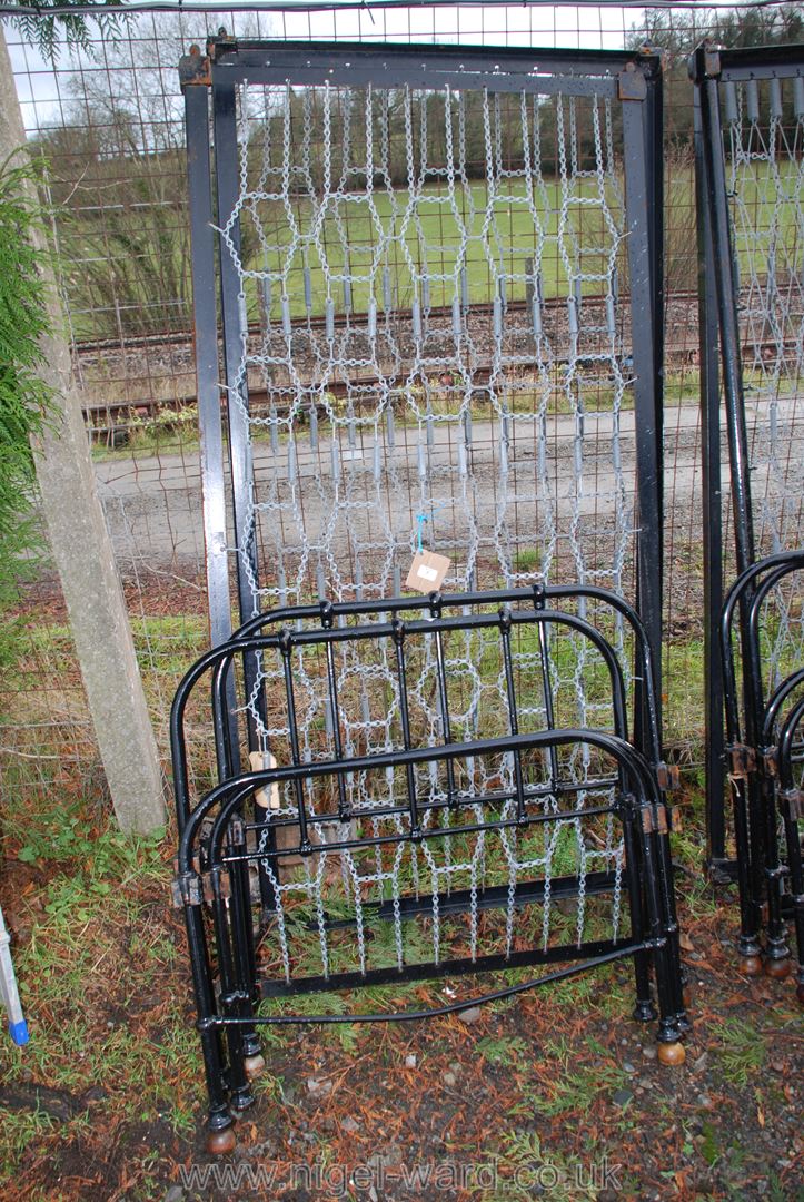 Two metal single beds on ball feet.