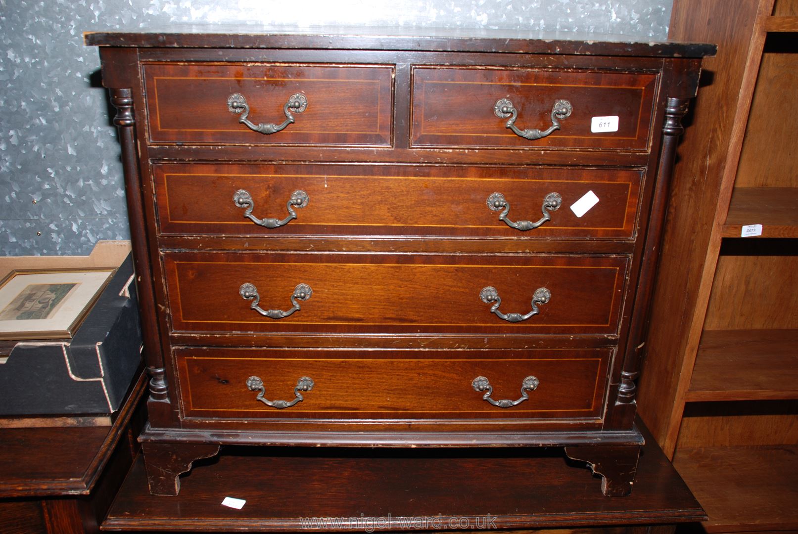 A contemporary dark Mahogany finished chest of three long and two short drawers,