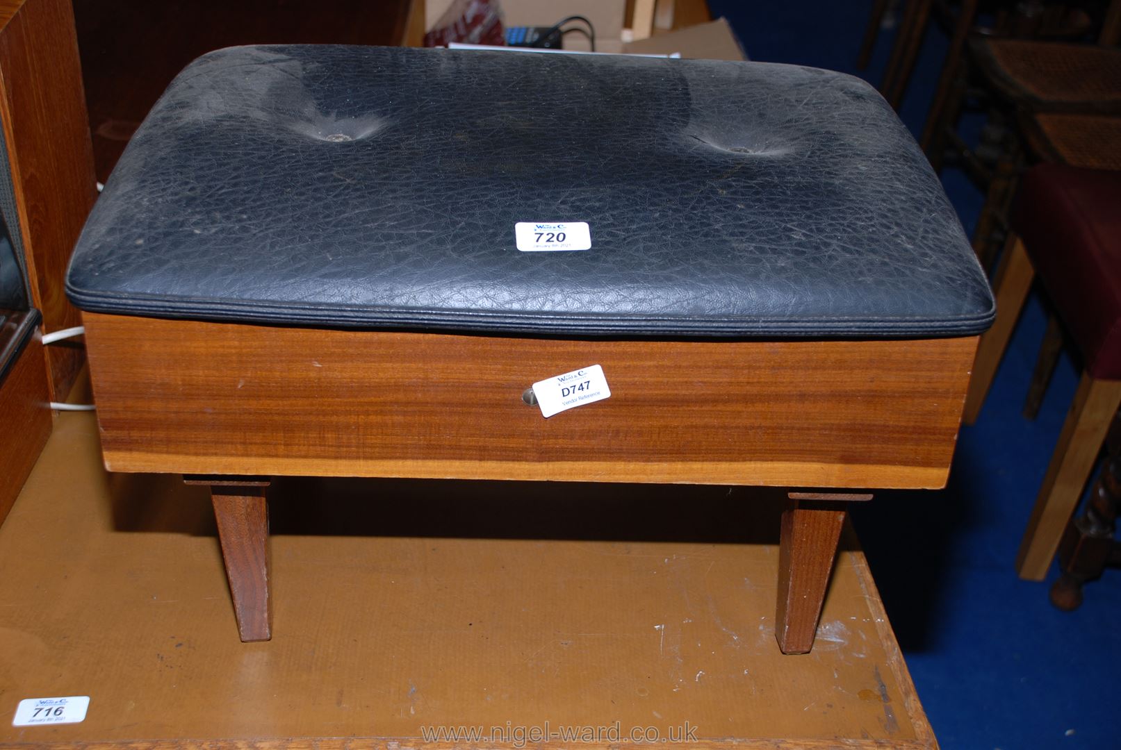 A vinyl upholstered foot stool/sewing box with interior sectional compartments 19 1/2" x 14".