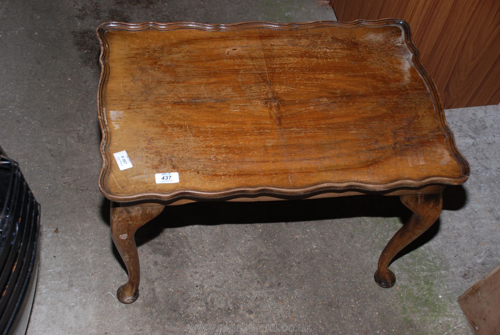 A pie-crust edged rectangular occasional table 25" x 16" x 16 1/2".