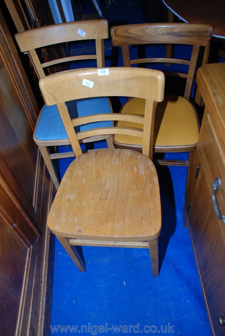 Three similar bent-wood style kitchen chairs.