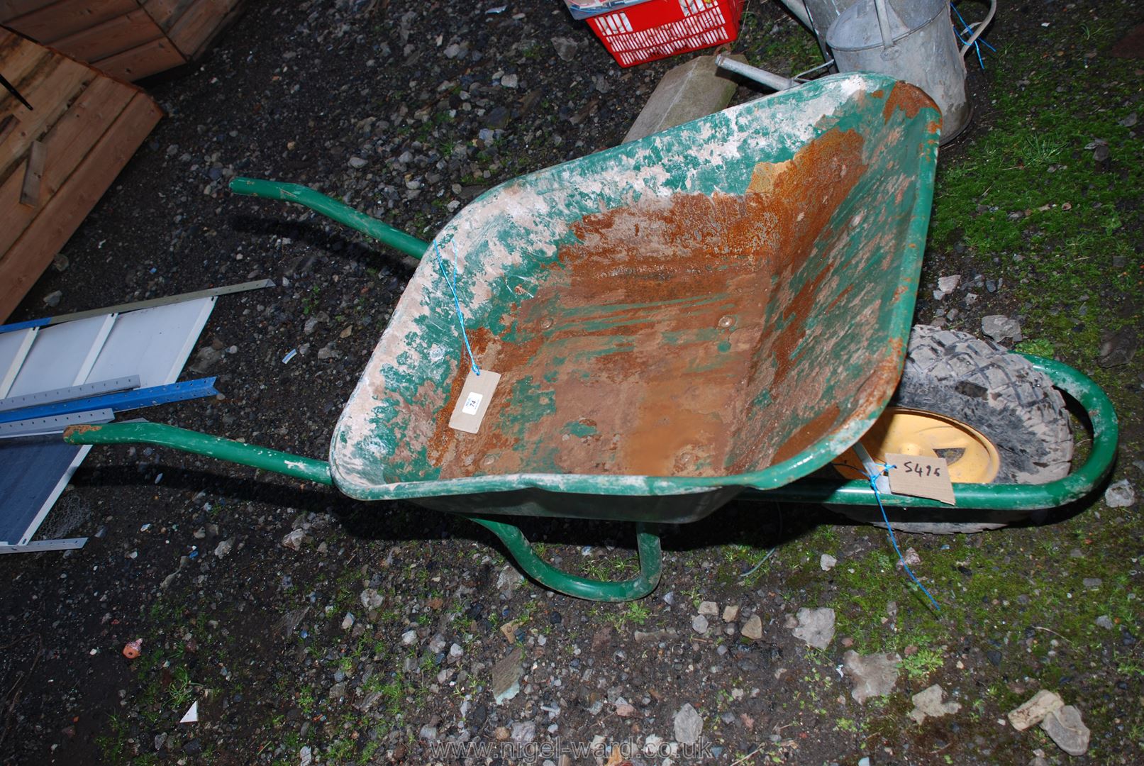 A green builder's Barrow with pneumatic tyre.