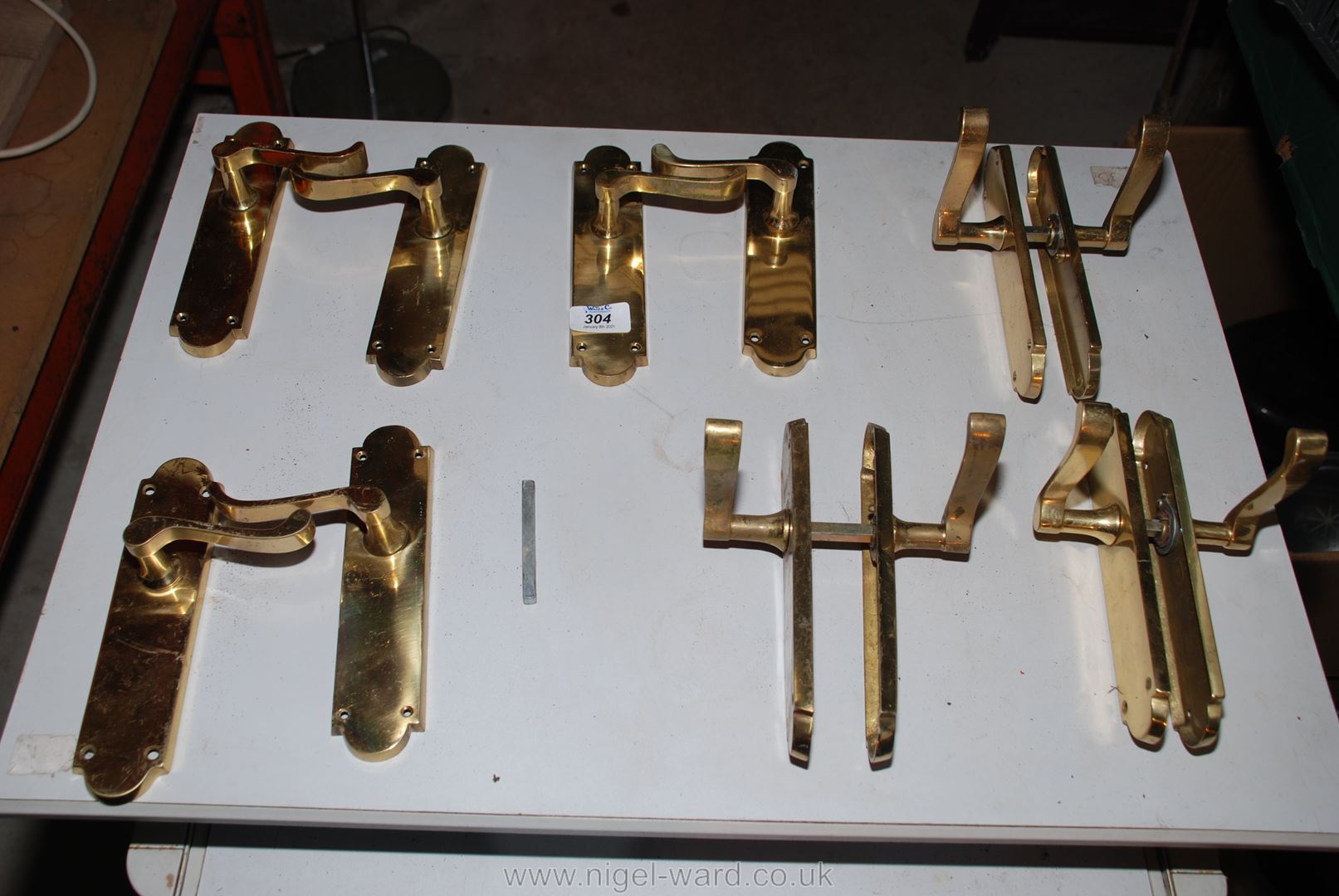 Six pairs of various brass door handles, some with spindles.