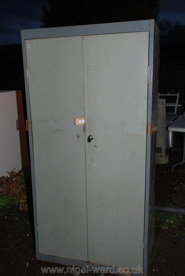 A metal two door stationery Cupboard.