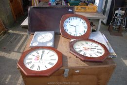Four wall clocks and a wooden tray.
