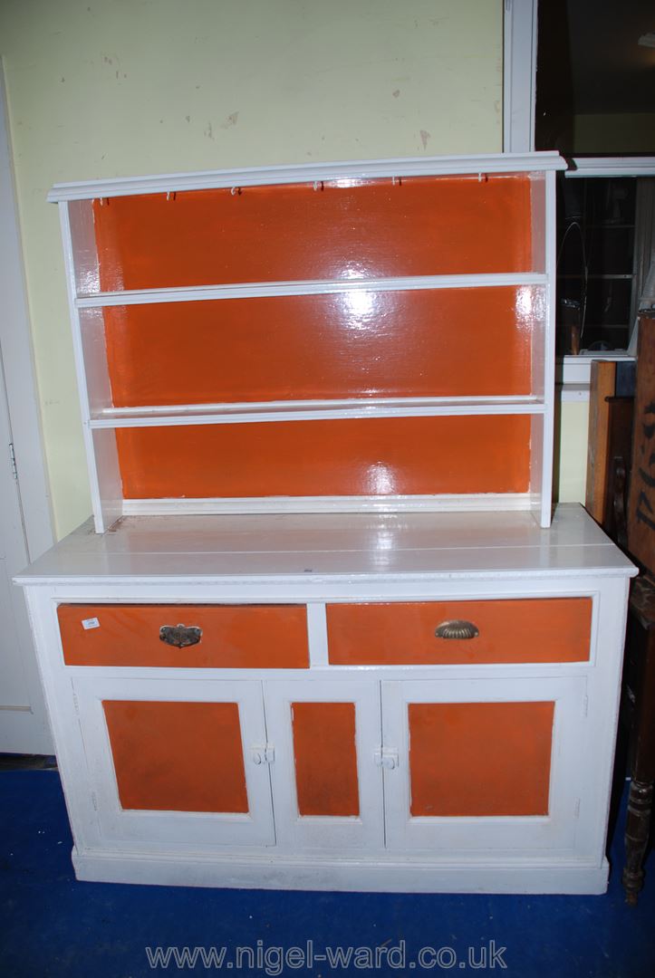 A striking white and orange painted dresser, 53" x 19 1/2" x 68" high.