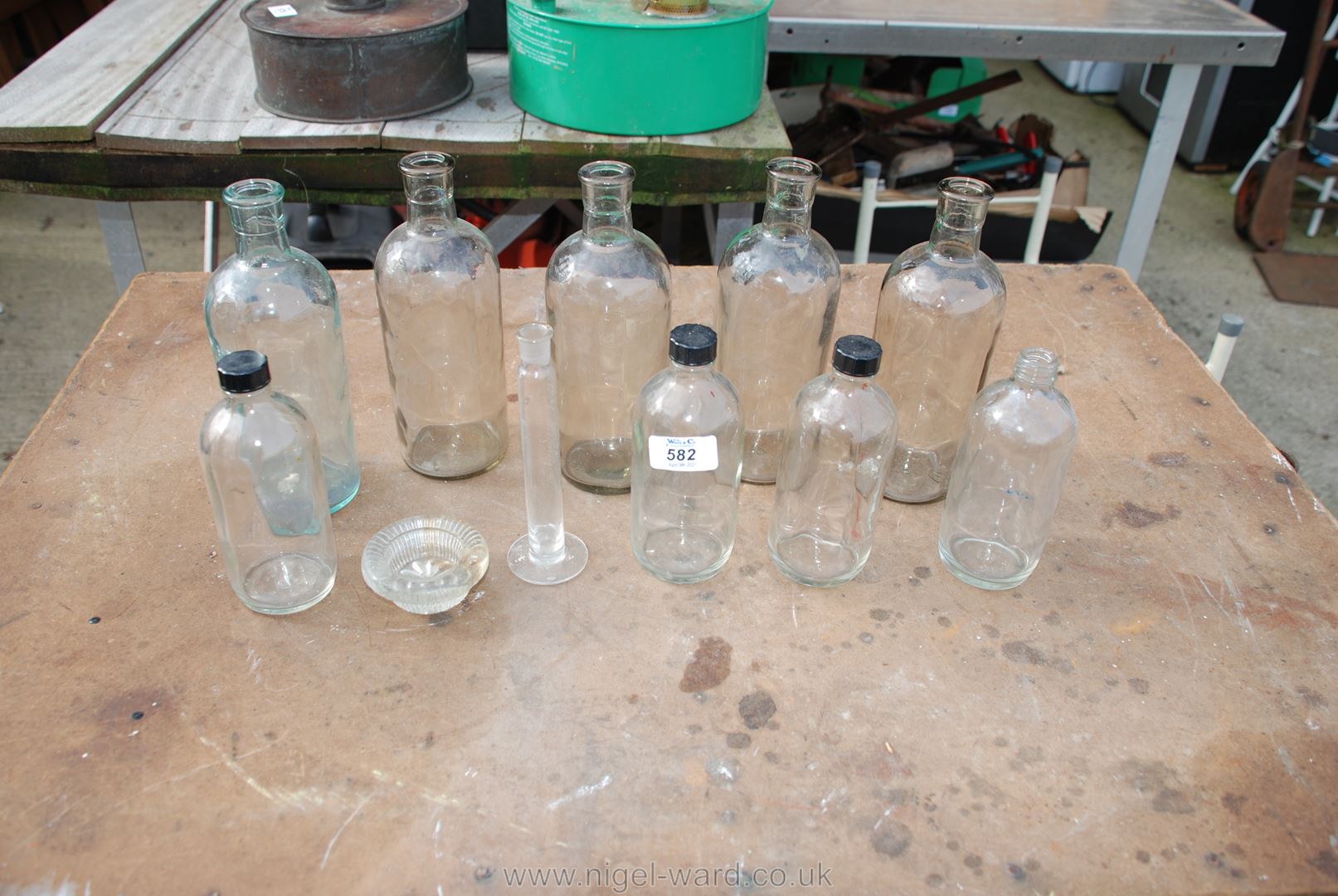 Bowl of clear glass chemist's bottles