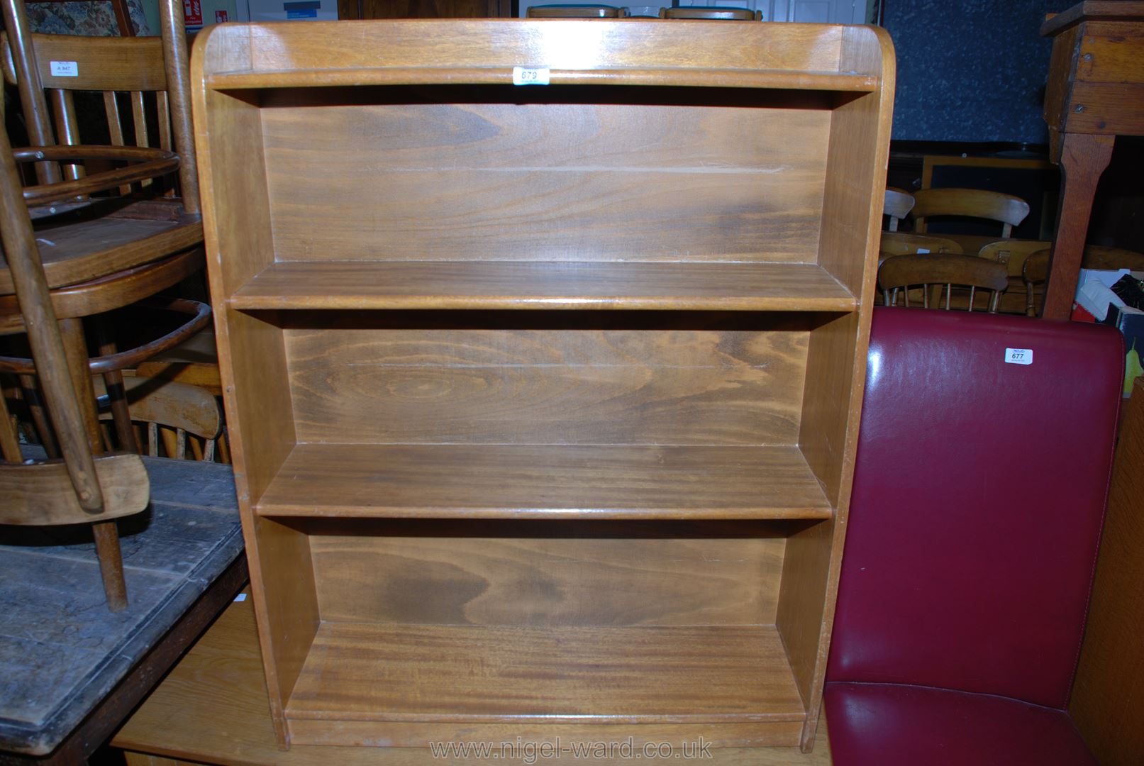 An Oak floor-standing bookcase of four graduated shelves, 30" x 9" x 39" high.