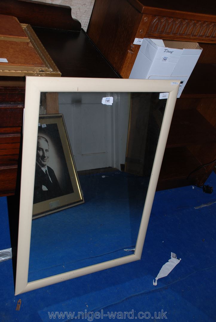 A framed wall-mirror.