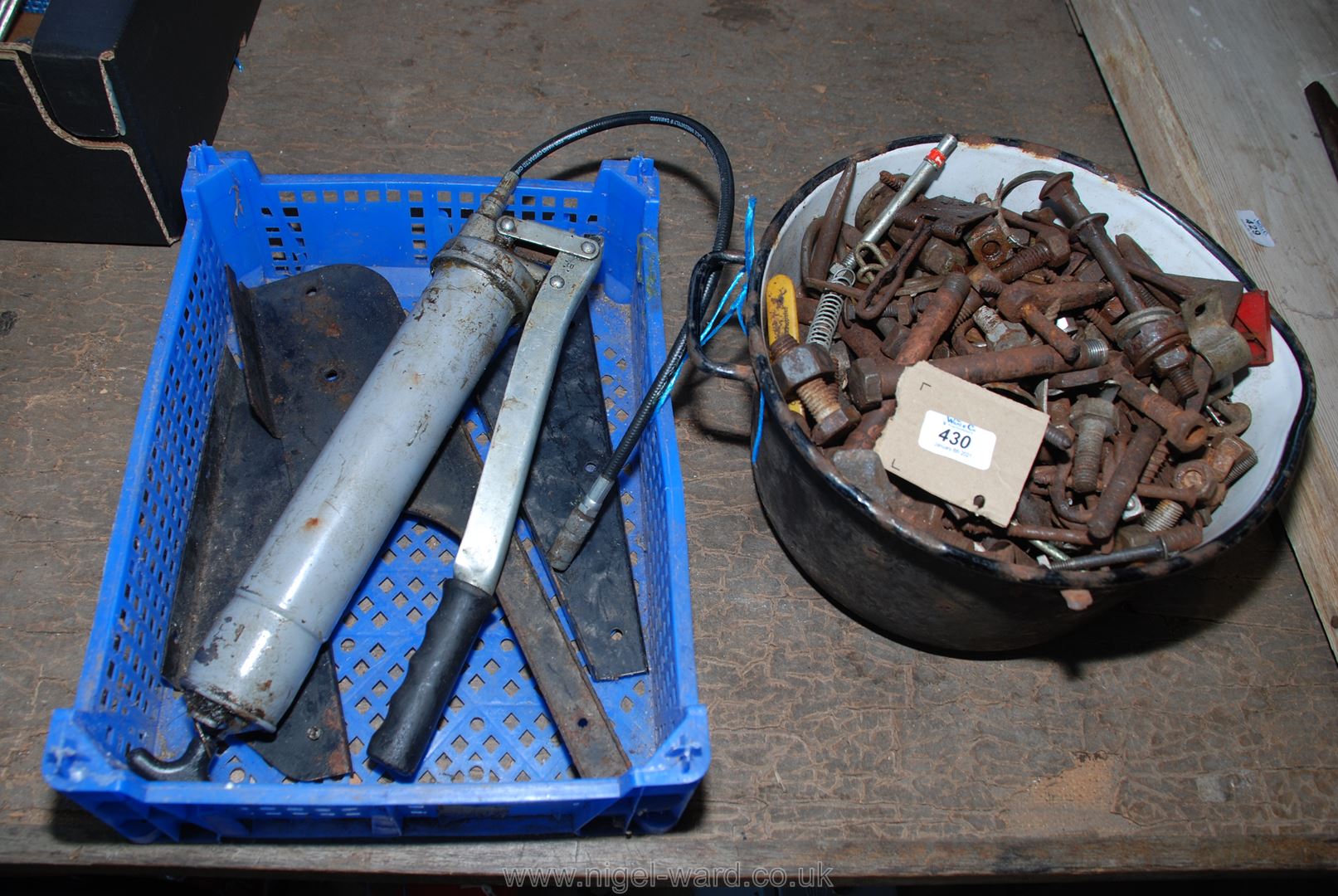 A cast iron pot with fastenings, a grease-gun, etc.