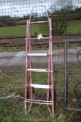 A set of metal step ladders converting to a ladder