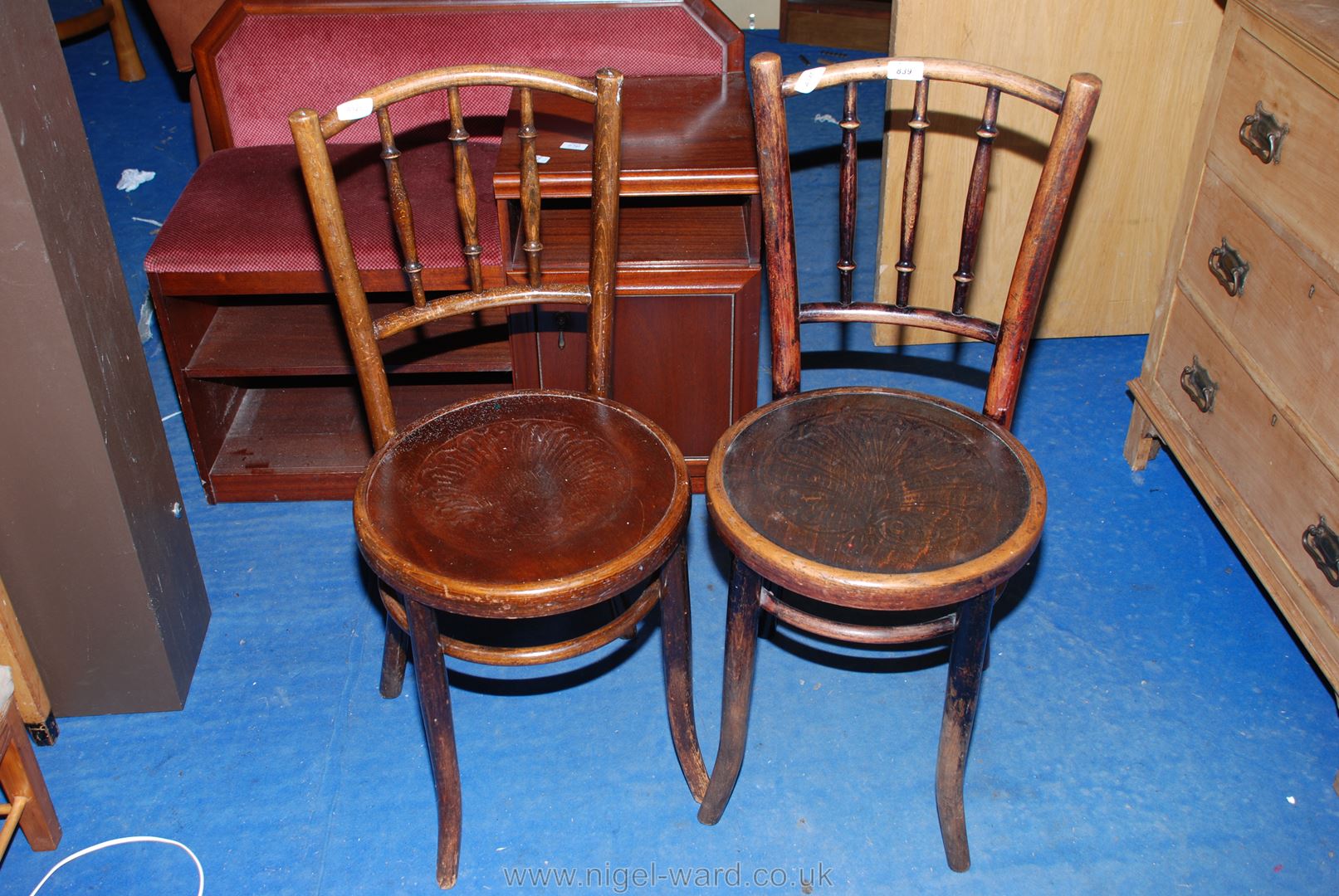 A pair of circular seated cafe type bent-wood chairs.