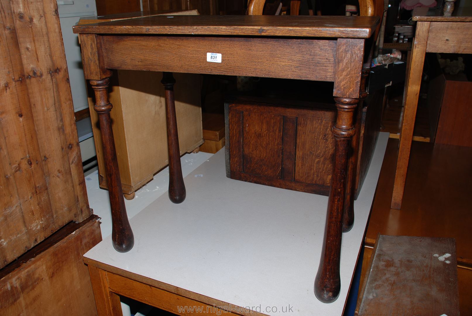 A rectangular occasional table with unusual tapering tear-drop shaped turned legs,