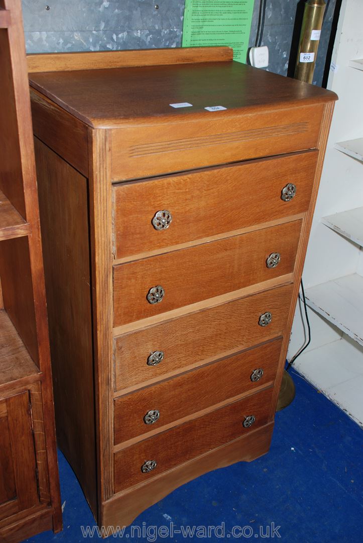 A light Oak five-drawer tallboy, 22" x 17" x 42".