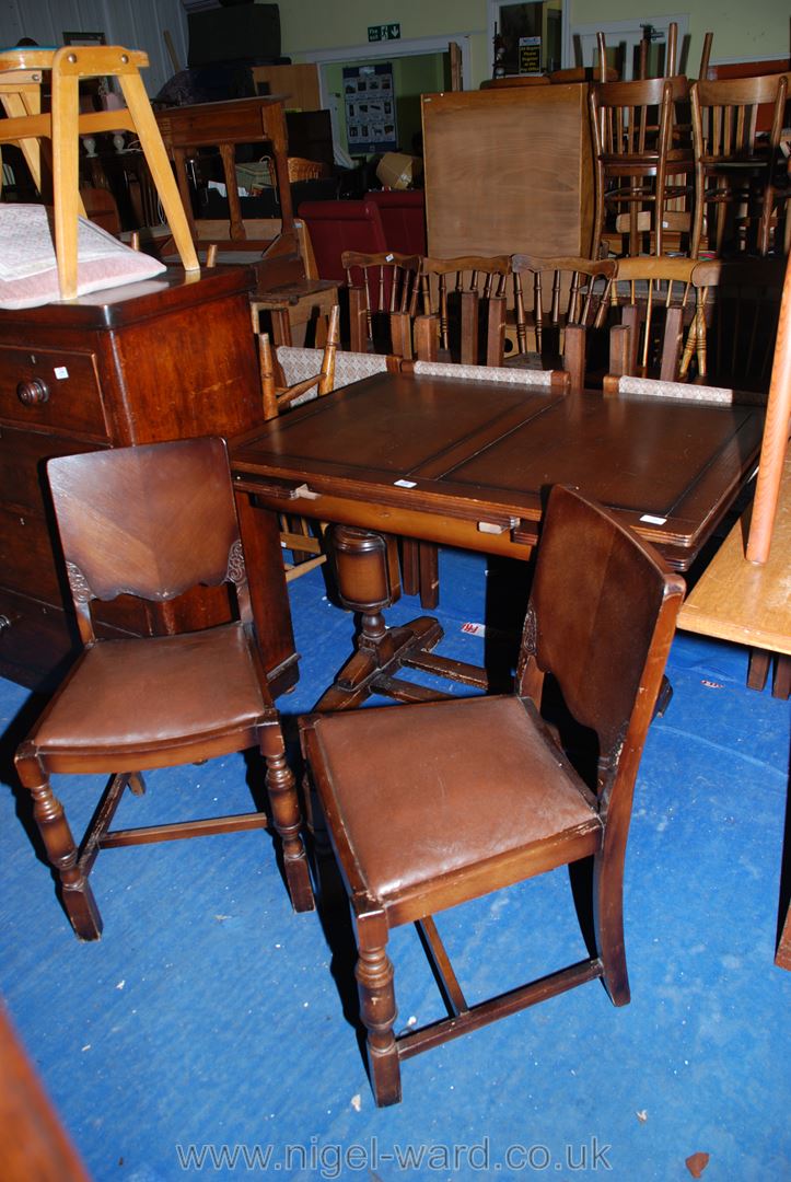 An Oak draw-leaf dining table 42" x 30" plus extensions and two chairs with drop-in seats and