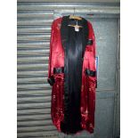 An oriental dressing gown, red ground with black lining and embroidered flowers,