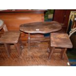 A small wooden table in the form of a tree trunk and two small stools, possibly a child's set,