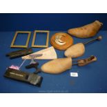 A quantity of miscellaneous wooden shoe lasts, wooden plaque with metal oak leaves and boars teeth,