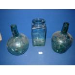 Two green glass carbuoys and a square sweet jar (lid missing), 11'' tall.