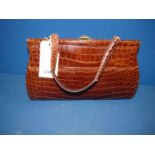 A vintage brown Crocodile handbag.