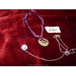 A 925 silver pendant on a purple cord and 925 silver set white stone on chain.