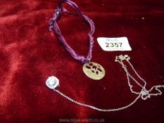 A 925 silver pendant on a purple cord and 925 silver set white stone on chain.
