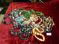 A box of costume jewellery including chunky stone necklaces, etc.