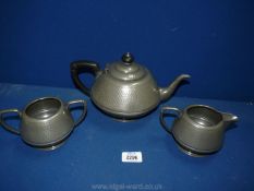 An Armada Pewter three piece Teaset with beaten surface detail.