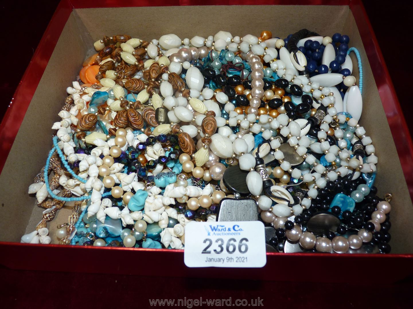 A box of miscellaneous vintage beads and necklaces.