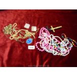 A quantity of costume beads, earrings, necklaces, crucifix, etc.