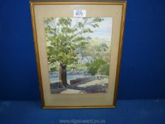 A framed and mounted Watercolour depicting a country landscape with church and country lane,