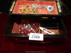 An oriental Musical jewellery box containing miscellaneous vintage brooches, necklace, etc.