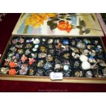 A vintage chocolate box containing vintage earrings including a pair of 'Tommy Steel' clip-ons and