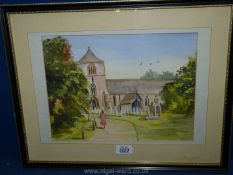 A framed Watercolour depicting a lady in red walking towards a village church, signed lower right,