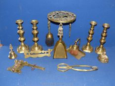 A quantity of Brass including a trivet, two pairs of brass candlesticks, three bells, etc.