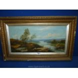 A gilt framed Oil on canvas depicting a river landscape with rolling hills in the distance and