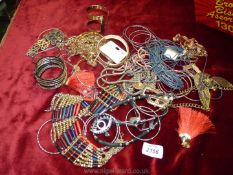 A quantity of costume jewellery including bangles, necklaces, ear-rings, etc.