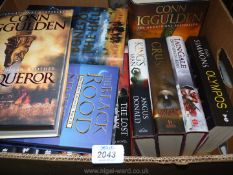 A box of hardback novels including Conn Iggulden, lain Gale,