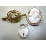 A yellow metal mounted brooch/pendant with a cameo depicting a lady of elegance 1 1/16'' x 7/8'',