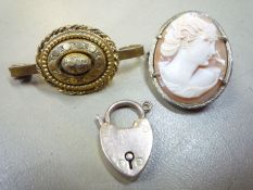 A yellow metal mounted brooch/pendant with a cameo depicting a lady of elegance 1 1/16'' x 7/8'',