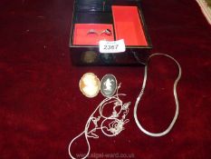 A small musical jewellery box containing silver chains, Wedgwood brooch, Cameo brooch, silver rings,