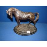 A bronzed finished brass Horse with saddle on a plinth. 10 1/2" tall x 11 1/2" long.