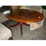 A most attractive Mahogany low oval Occasional Table having a turned pillar, four splay feet,